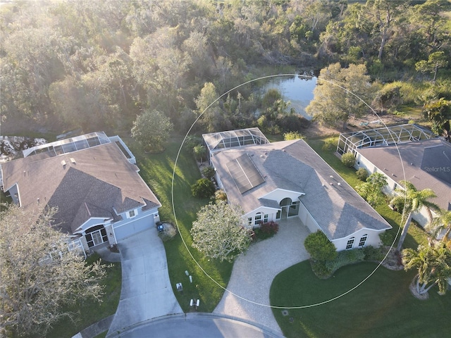 birds eye view of property with a water view and a forest view