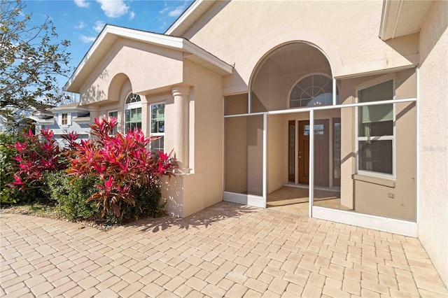 view of exterior entry with stucco siding