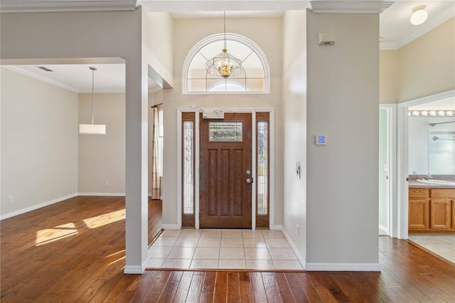 foyer featuring hardwood / wood-style floors, a high ceiling, and crown molding