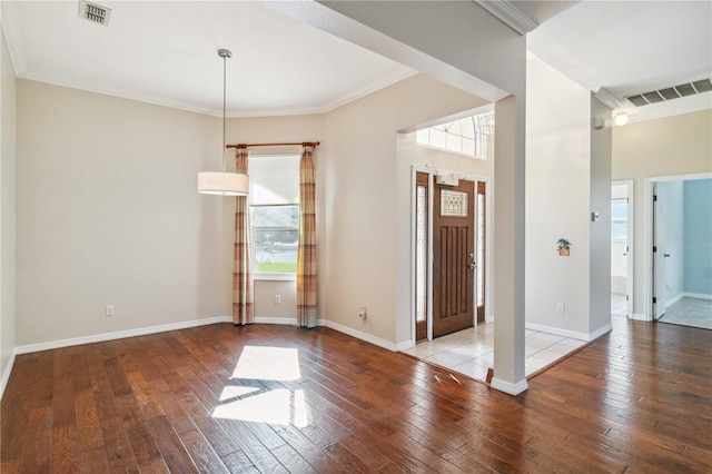 entrance foyer featuring ornamental molding, visible vents, baseboards, and hardwood / wood-style flooring