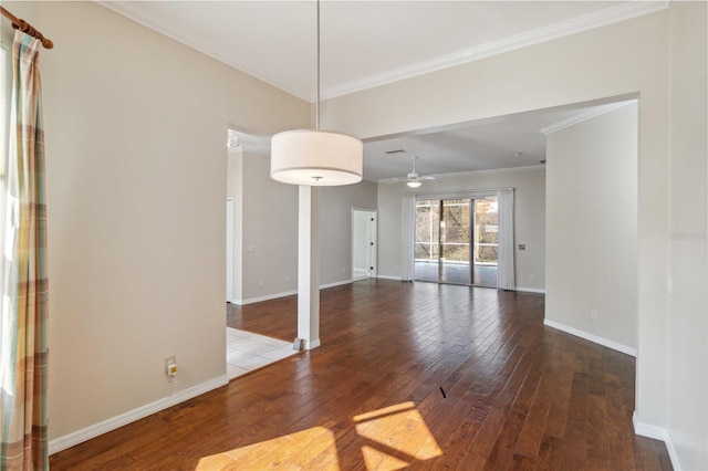 interior space with baseboards, hardwood / wood-style floors, and crown molding