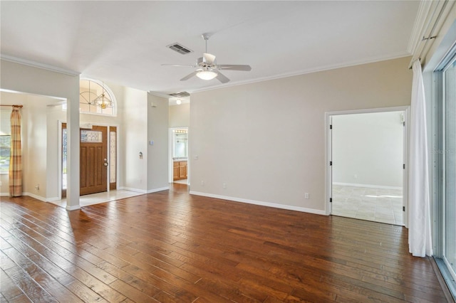 interior space featuring a ceiling fan, baseboards, hardwood / wood-style floors, plenty of natural light, and crown molding