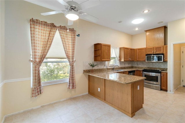 kitchen with brown cabinetry, appliances with stainless steel finishes, light stone counters, a peninsula, and open shelves