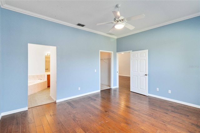 unfurnished bedroom featuring baseboards, visible vents, ornamental molding, and hardwood / wood-style floors