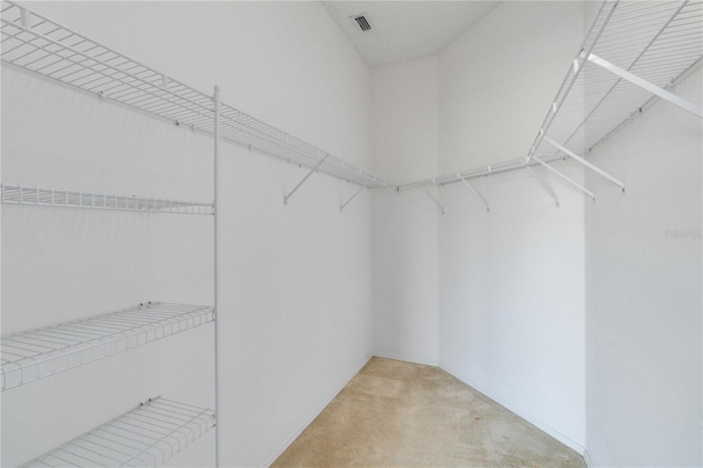 spacious closet featuring light carpet and visible vents