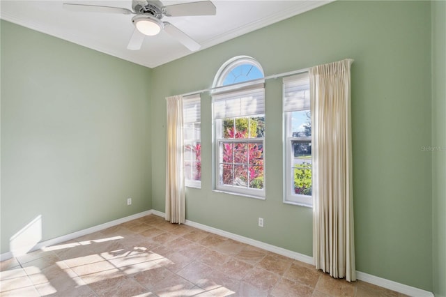 spare room with ceiling fan and baseboards