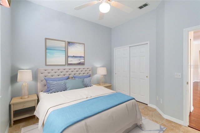 bedroom featuring light tile patterned floors, a closet, visible vents, a ceiling fan, and baseboards