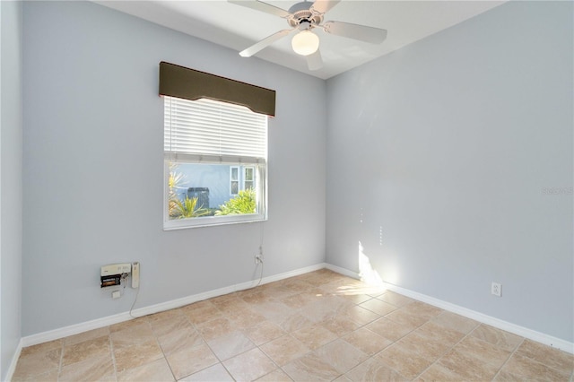 empty room with baseboards and a ceiling fan