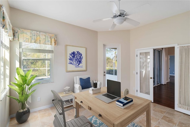 home office featuring french doors, ceiling fan, and baseboards