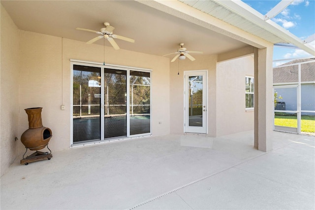 view of patio / terrace with glass enclosure and ceiling fan