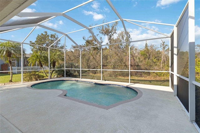 pool with a patio and glass enclosure