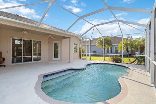 outdoor pool featuring ceiling fan, glass enclosure, and a patio area