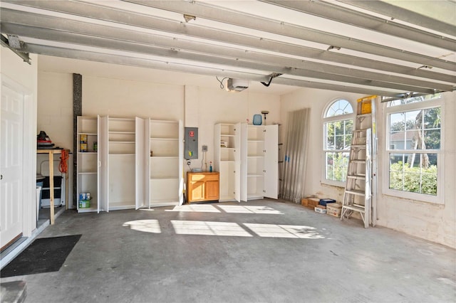 garage featuring electric panel and a garage door opener