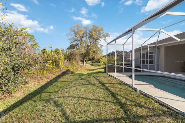 view of yard with glass enclosure and an outdoor pool