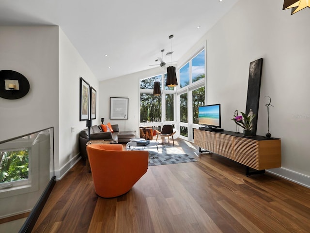 living area featuring high vaulted ceiling, baseboards, and dark wood-type flooring