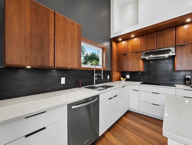 kitchen with dishwasher, a sink, light stone countertops, and white cabinets