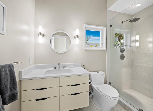 bathroom with toilet, a shower stall, and vanity