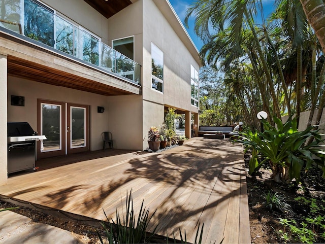 view of property exterior with a hot tub and stucco siding