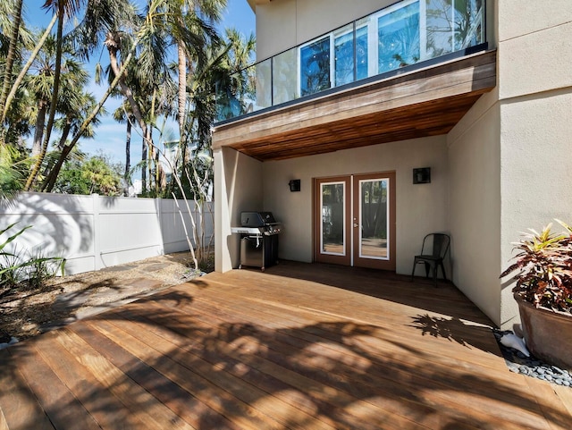 deck featuring a grill and fence