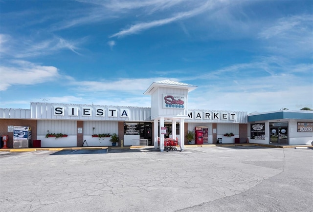 view of building exterior with uncovered parking