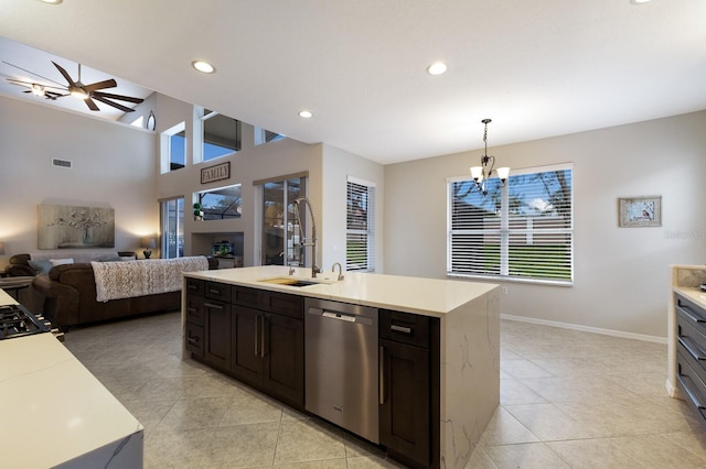 kitchen with dishwasher, light countertops, open floor plan, and a sink