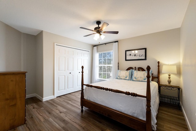 bedroom featuring ceiling fan, a closet, wood finished floors, and baseboards