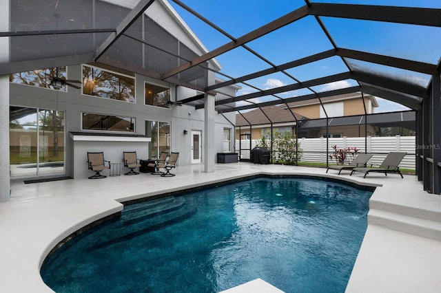 view of pool with a fenced in pool, glass enclosure, and a patio area