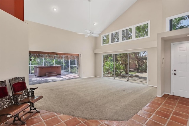 tiled living area featuring high vaulted ceiling, carpet, ceiling fan, and baseboards