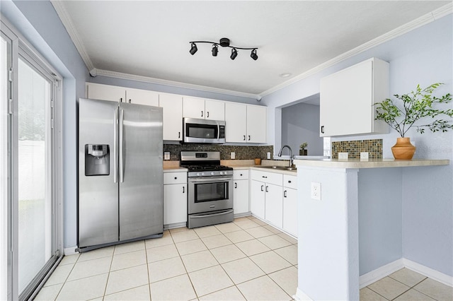 kitchen featuring appliances with stainless steel finishes, tasteful backsplash, a sink, and light tile patterned floors