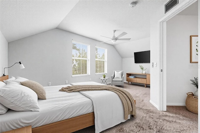 bedroom featuring a textured ceiling, visible vents, vaulted ceiling, and carpet flooring