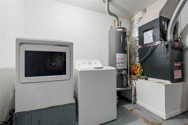 clothes washing area featuring concrete block wall, laundry area, washer and clothes dryer, heating unit, and water heater