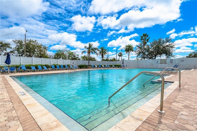 community pool featuring a patio and fence