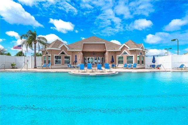 community pool featuring ceiling fan, a patio, and fence