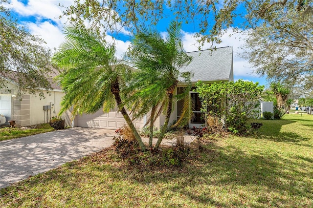 view of front of property with a garage, concrete driveway, and a front yard