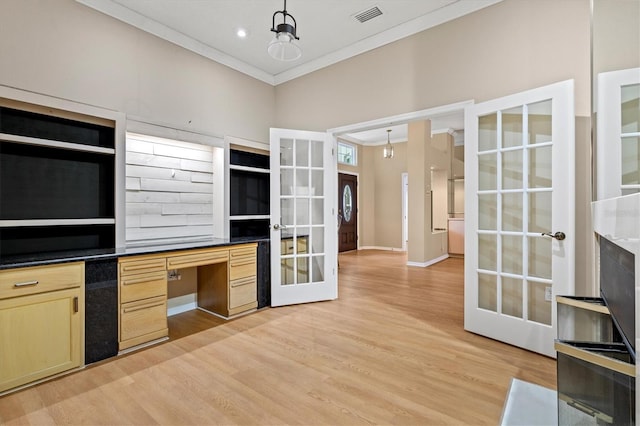 kitchen with visible vents, french doors, crown molding, light brown cabinetry, and built in desk