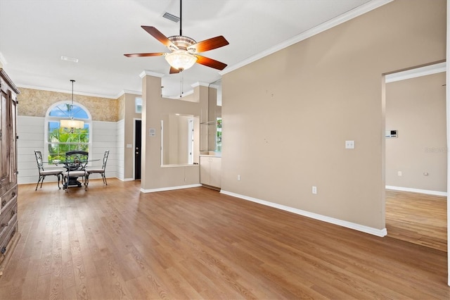 interior space featuring visible vents, light wood-style flooring, ornamental molding, ceiling fan, and baseboards