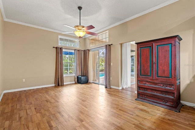 unfurnished bedroom with access to exterior, crown molding, light wood finished floors, ceiling fan, and baseboards