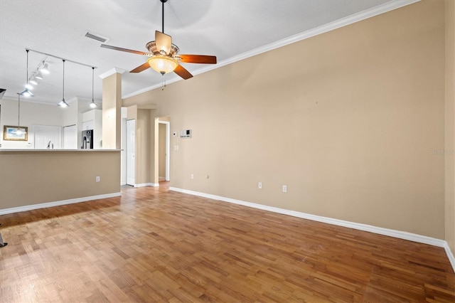 unfurnished living room with light wood-style floors, visible vents, ornamental molding, and a ceiling fan