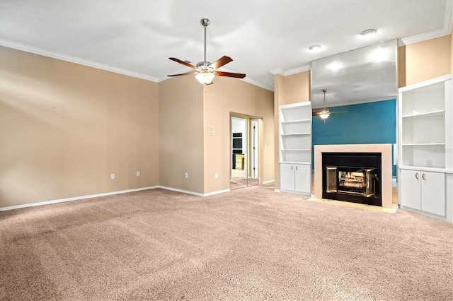 unfurnished living room featuring a ceiling fan, carpet flooring, crown molding, and a multi sided fireplace