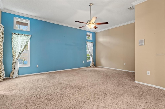 unfurnished room featuring carpet floors, ornamental molding, plenty of natural light, and baseboards