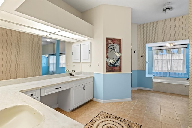 bathroom featuring tile patterned floors, vanity, baseboards, and wallpapered walls