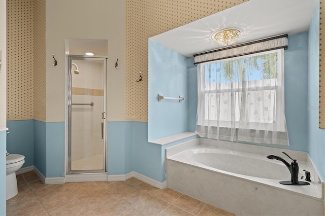 full bath featuring a stall shower, a garden tub, toilet, and tile patterned floors