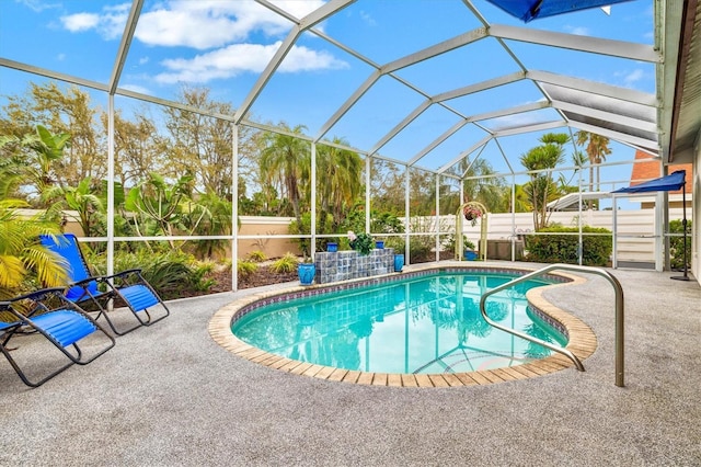 view of swimming pool featuring glass enclosure, a patio, fence, and a fenced in pool