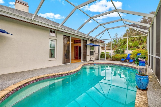 pool with a lanai and a patio area