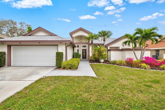 view of front of house featuring an attached garage, a front lawn, concrete driveway, and stucco siding