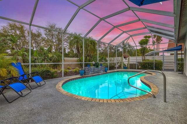 view of pool with a fenced in pool, glass enclosure, and a patio