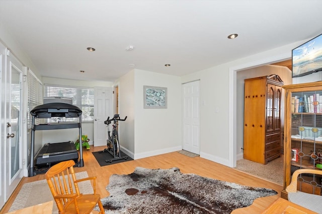 workout area with light wood finished floors, baseboards, and recessed lighting