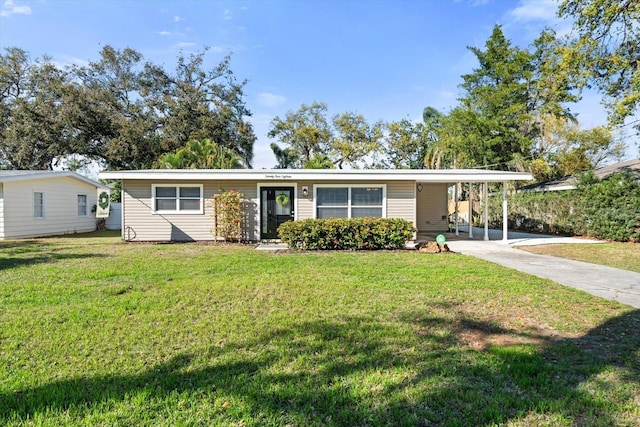 view of front of house featuring concrete driveway, an attached carport, and a front yard