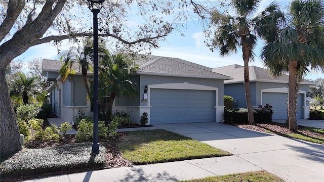 single story home with driveway and stucco siding