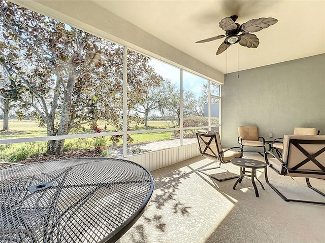 sunroom / solarium with a ceiling fan